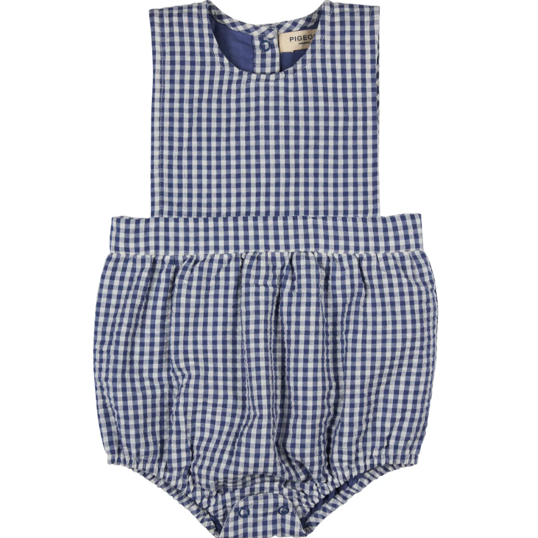 Blue and white checkered baby romper with a brand label. BABY ORGANIC COTTON SEERSUCKER BIB ROMPER - NAVY | PIGEON ORGANICS