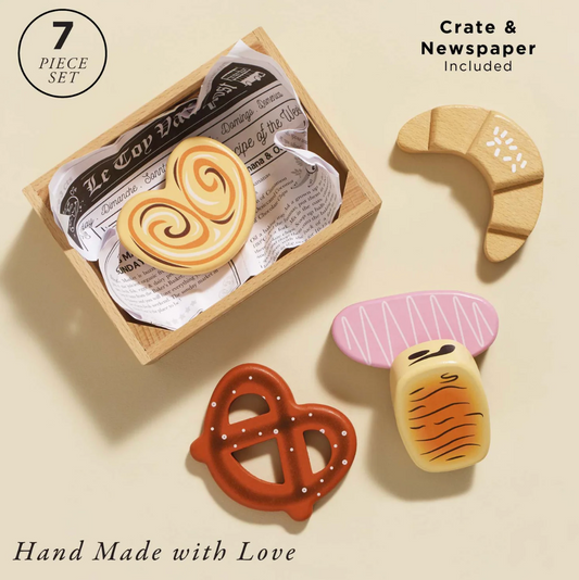 Set of handcrafted wooden toys shaped like a heart, crescent moon, pretzel, and mushroom on a beige background. BAKERY & PATISSERIE MARKET CRATE WOODEN TOY | LE TOY VAN