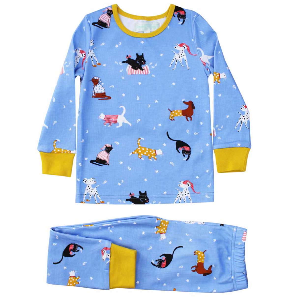 Powell Craft children's cat and dog print cotton jersey pyjama set laid flat on a white background with top and trousers separated; cornflower blue fabric with all-over cats and dogs in pyjamas and nightcaps print; small turquoise Powell Craft label visible at the inner neckline of the round-neck top; mustard yellow ribbed neckband, sleeve cuffs and trouser ankle cuffs; white stars and crescent moon scatter clearly visible on the blue ground; long-sleeve top above and folded elasticated-waist trousers with