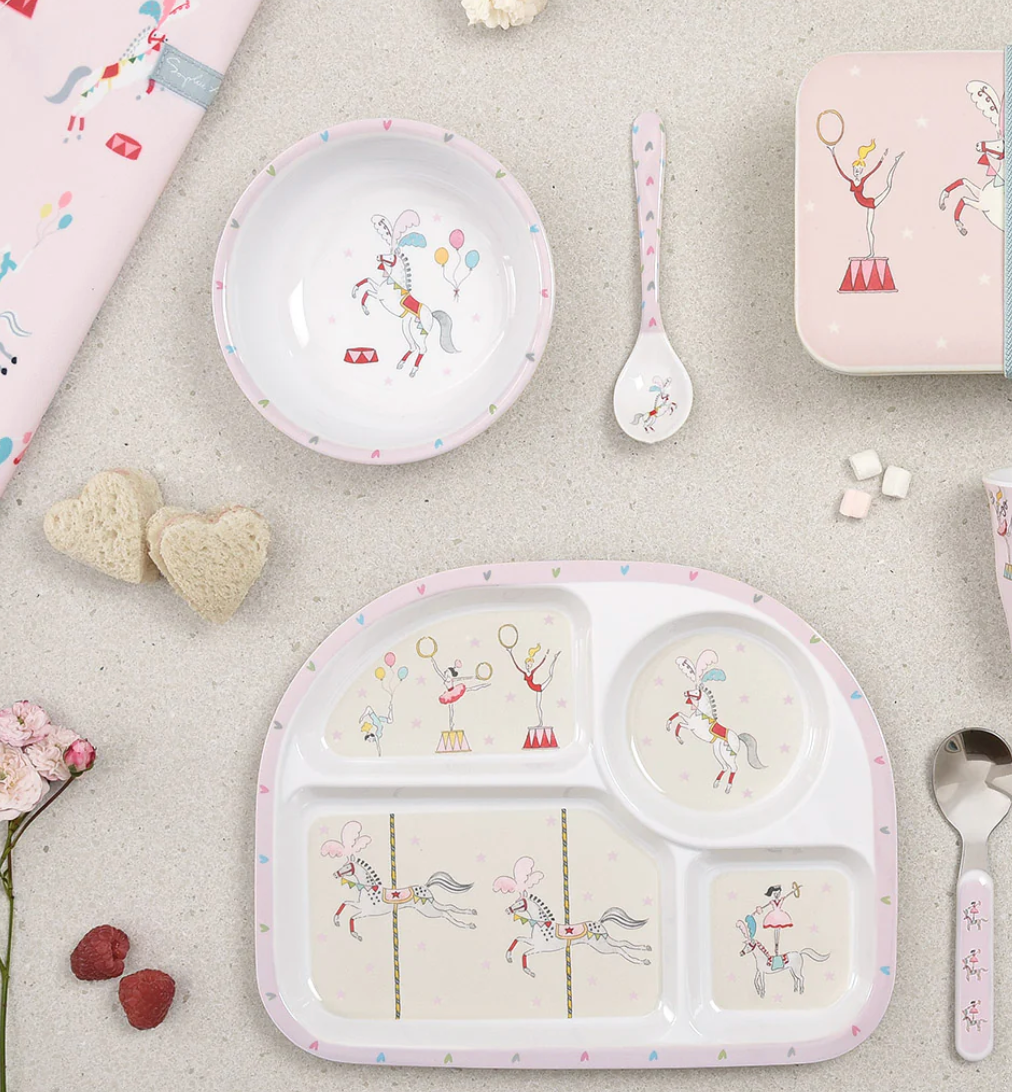 Children's tableware set with bowls, plates, and cutlery featuring cartoon characters on a light gray surface. CHILDREN'S MELAMINE DIVIDER PLATE - FAIRGROUND PONIES | SOPHIE ALLPORT