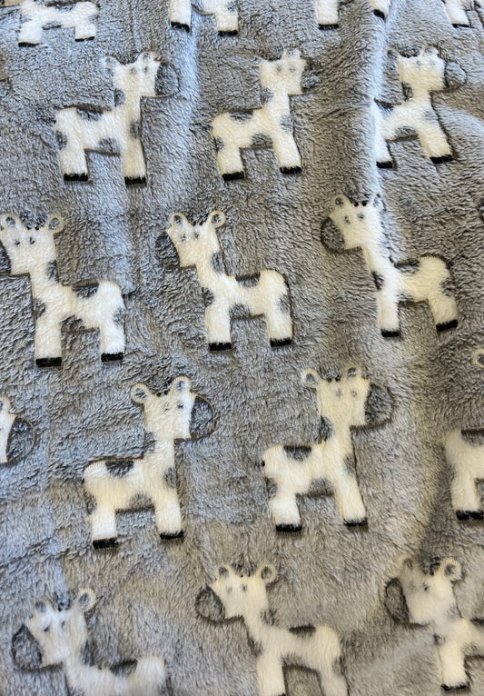 Pattern of white giraffe shapes on a textured gray background. COSY BABY WRAP | GREY GIRAFFE