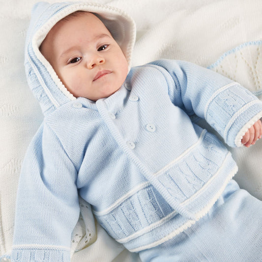 Baby in a blue knitted outfit lying on a soft surface. SOFT KNIT LINED BABY JACKET - BLUE | DANDELION
