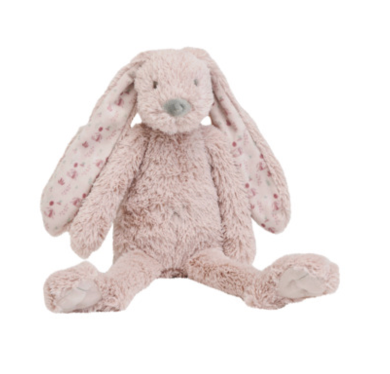 A plush stuffed bunny toy in a pale blush pink color, featuring long floppy ears with small darker pink spots, a grayish nose, and sitting with its legs extended against a plain white background.