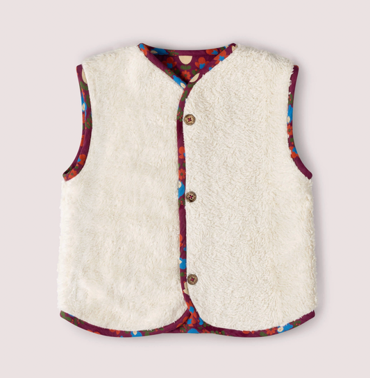 Little Green Rascals Folk Birds reversible gilet — sherpa side front flat lay showing thick fluffy natural cream organic unbleached cotton sherpa with folk birds print fabric as contrast binding trim around the neckline, armholes and hem; three branded coconut shell buttons at the front