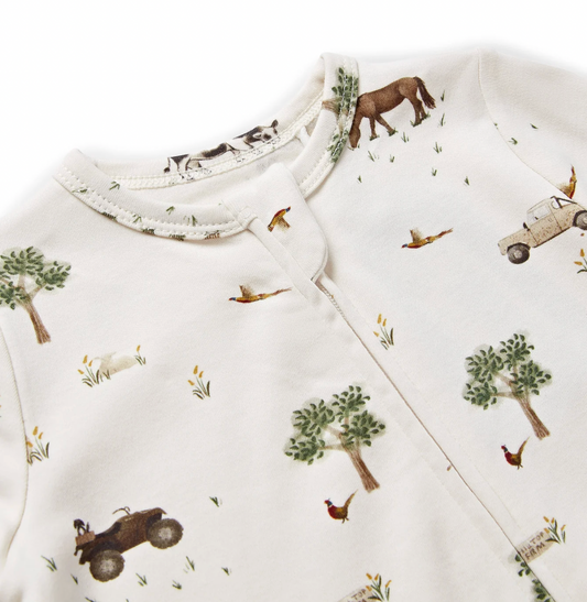 Round neckline with narrow ribbed or bound neckband in the same On The Farm print; zip fastening visible centrally from the neckline downward; print in sharp close-up: chestnut bay horse grazing upper right; cream vintage Land Rover-style vehicle to the right; pheasant in flight with russet-orange breast and long tail feathers upper centre; second pheasant standing upright with red wattle and iridescent green-brown plumage lower right; dark quad bike with rider lower left; rounded green trees; watercolour g