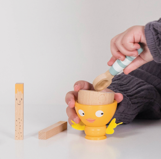 Six-piece wooden play food breakfast set from Le Toy Van, featuring a magnetic egg, two toast soldiers, wooden spoon and felt-wing egg cup.