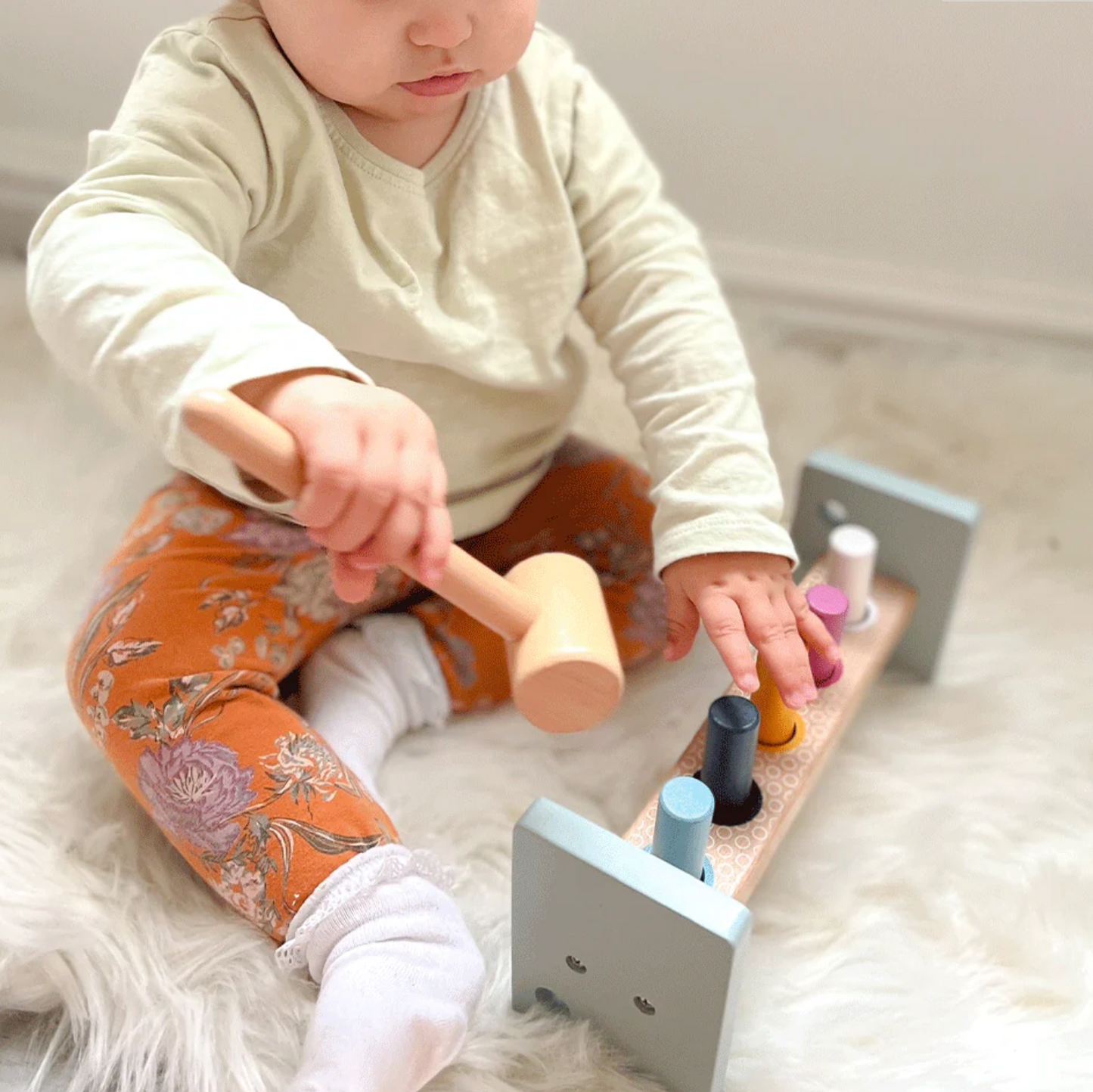 Child playing with wooden toys on a soft surface WOODEN HAMMER BENCH | BIGJIGS