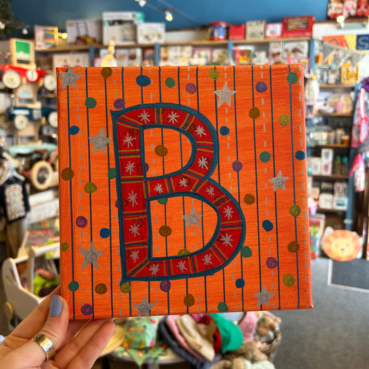Close-up detail of the textured, multi-dimensional layered paint technique on the B. Sloan & Daughter monogram canvas.