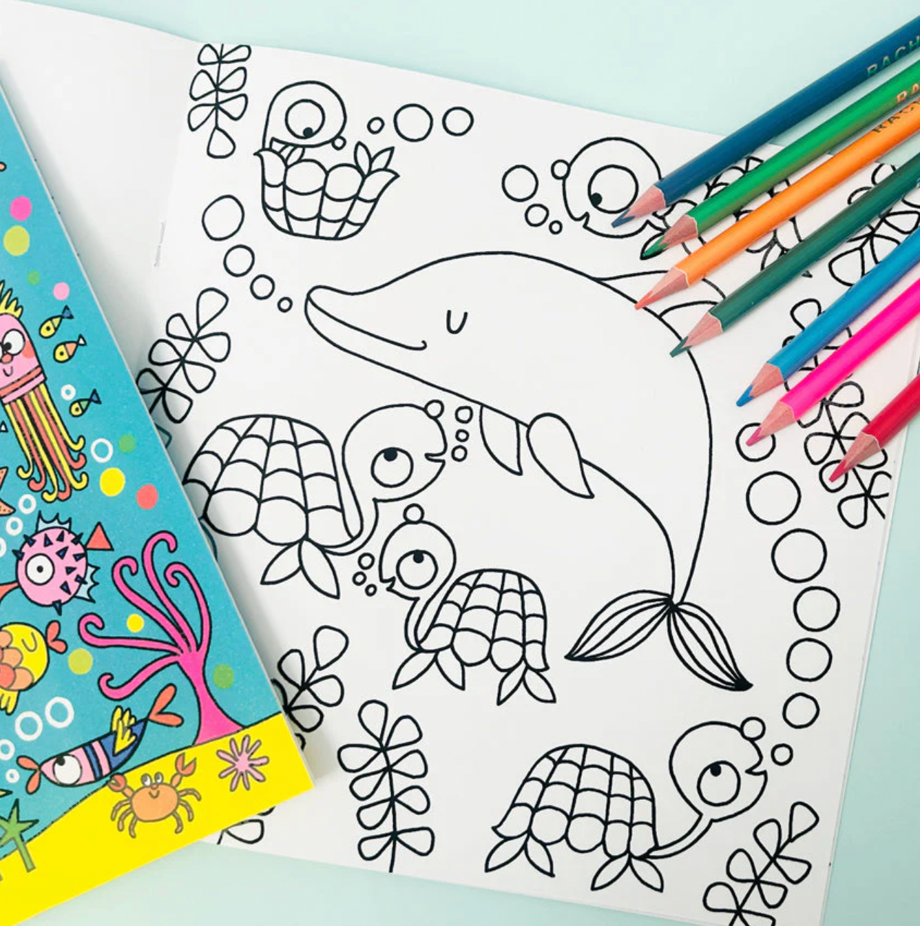 Coloring book with a dolphin design and coloring pencils. Rachel Ellen Love Our Oceans Colouring Book | Annabel's of Cranbrook