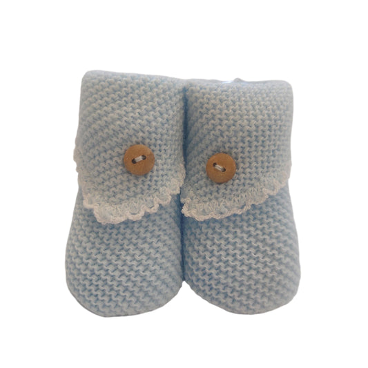 Pair of blue crochet-knit baby booties shown from the front on a white background; each bootie has a pale scalloped turn-down flap and a small wooden-look button