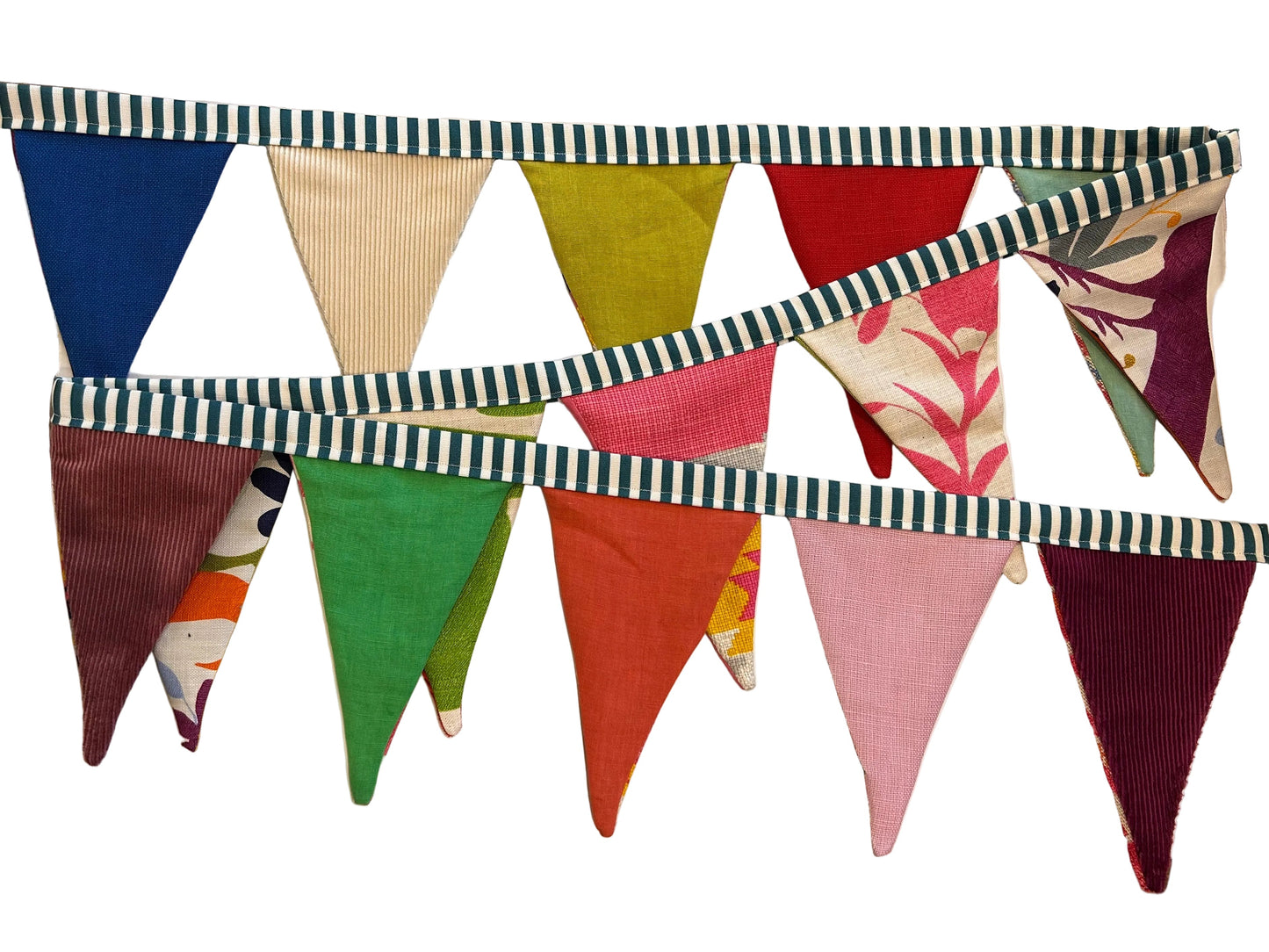 Colorful fabric triangle banner with striped border on a wooden surface