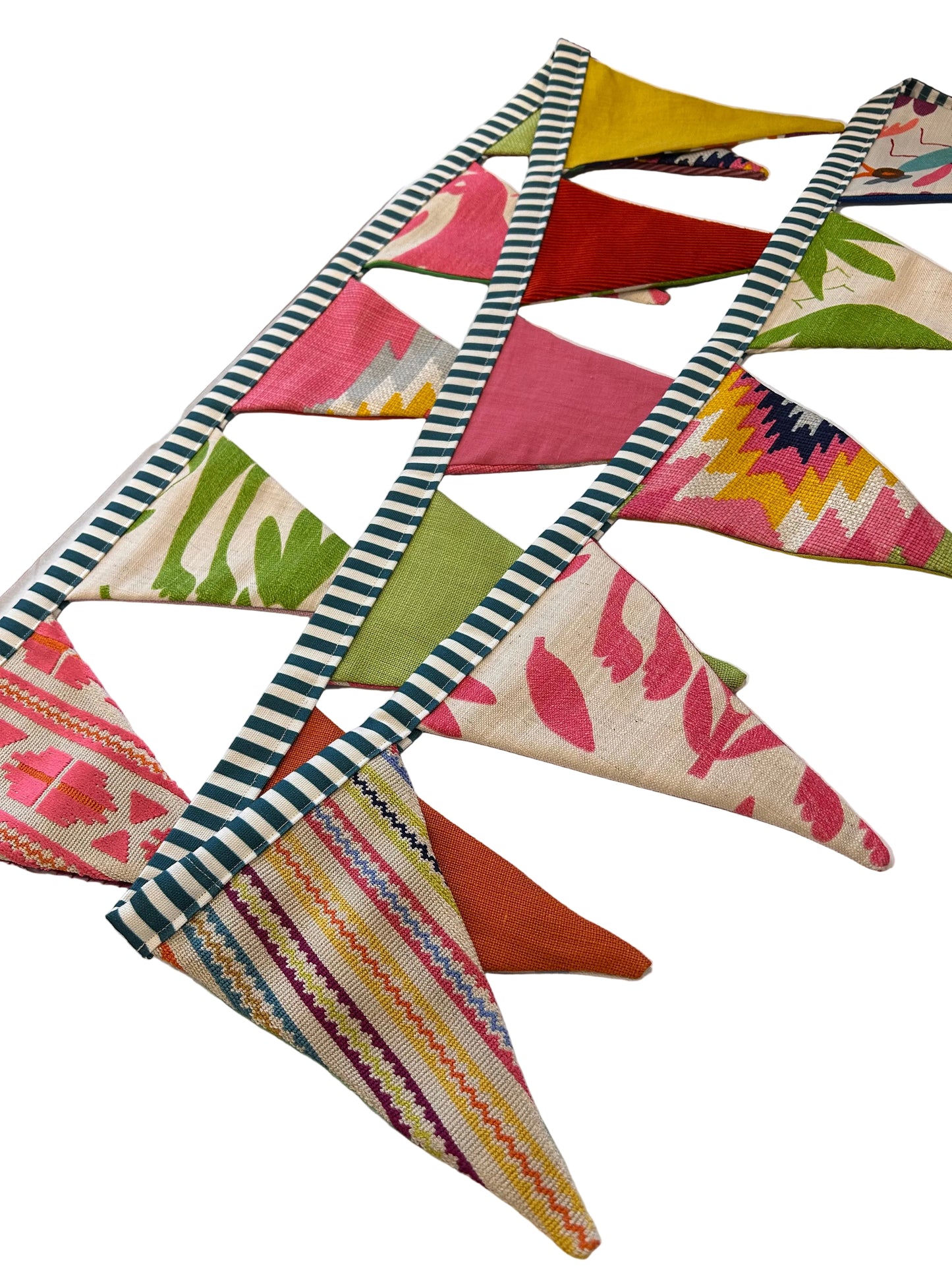 Colorful fabric triangles arranged in a pattern on a white surface.