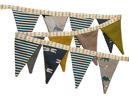 Fabric bunting with striped and patterned triangles on a white surface.