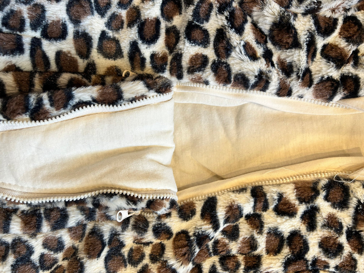 Nursery Time leopard print baby snowsuit — open view showing the dual zip front fastening and cream cotton lining against the fluffy faux fur outer