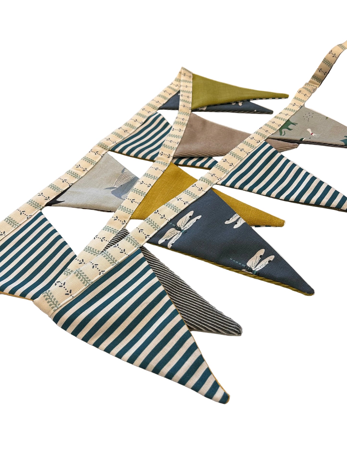 Collection of fabric triangles with various patterns on a white surface