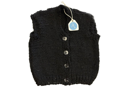 Black knitted vest with buttons on a white background