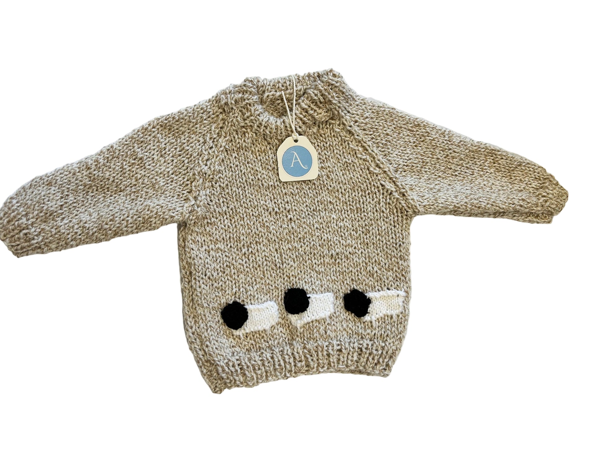 Knitted sweater with black and white details on a white surface