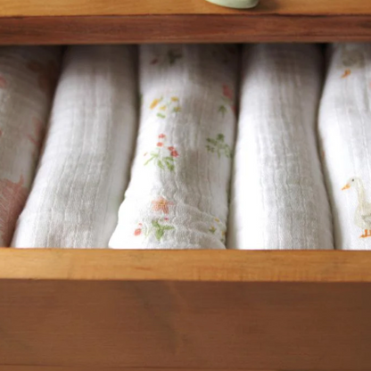 Folded fabric swaddles in a wooden drawer ADEN + ANAIS 5 PACK BABY MUSLIN SQUARES - COUNTRY FLORAL