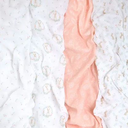 Close-up of a pink arm with a textured pattern against a white background ADEN + ANAIS COTTON BABY SWADDLE 4 PACK - BLUSHING BUNNIES