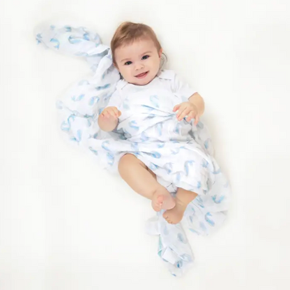 Baby wrapped in a blue and white patterned blanket. ADEN + ANAIS COTTON BABY SWADDLE 4 PACK - NATURAL HISTORY