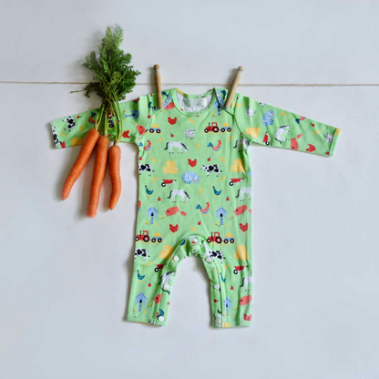 Green baby onesie with farm animal pattern. BABY COTTON FOOTLESS FARMYARD SLEEPSUIT WITH POPPERS | POWELL CRAFT 