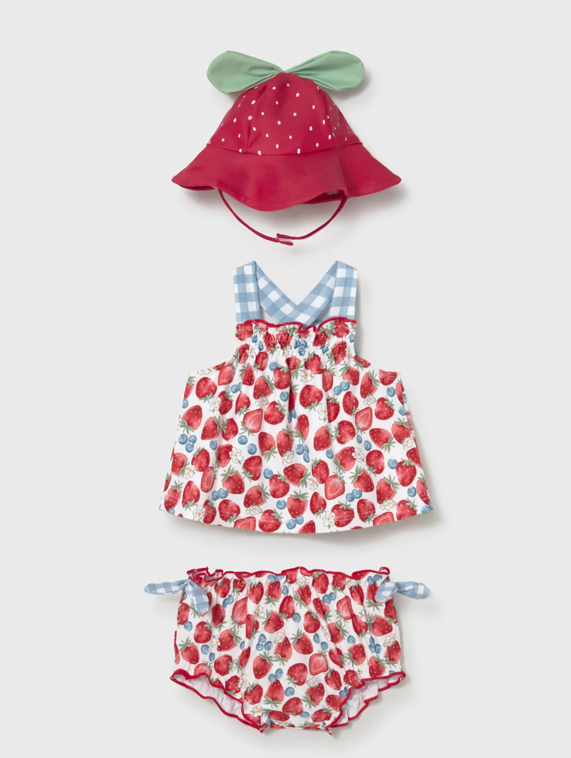 Mayoral baby girls strawberry swim beach set — all three pieces on white background: deep red polka dot sun hat with sage green leaf tabs and red chin tie (top), sleeveless strawberry and blueberry watercolour print swim top with pale blue gingham cross-back straps and red picot trim chest edge (centre), and matching swim knickers with red picot frill leg trim and pale blue gingham tie bows at the sides (bottom)