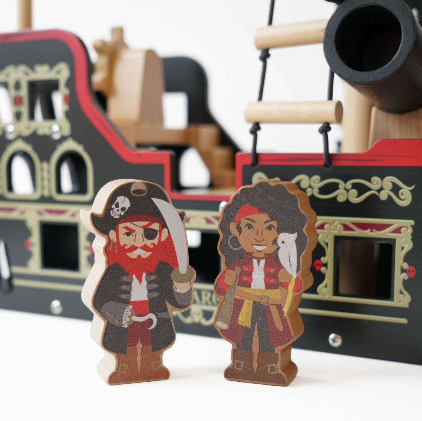 Wooden pirate figures in front of a toy pirate ship BARBAROSSA WOODEN PIRATE SHIP & CHARACTERS | LE TOY VAN 