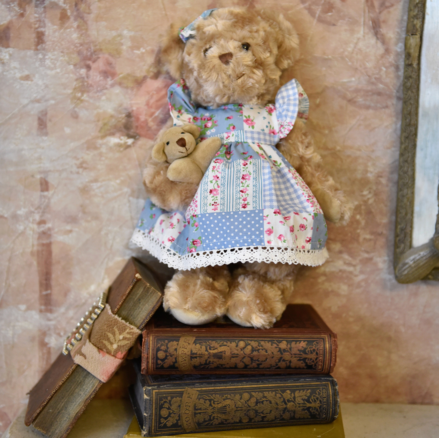 Teddy bear in a patchwork dress standing on vintage books. BLUE FLORAL PATCH-WORK DRESS TEDDY & BABY | POWELL CRAFT
