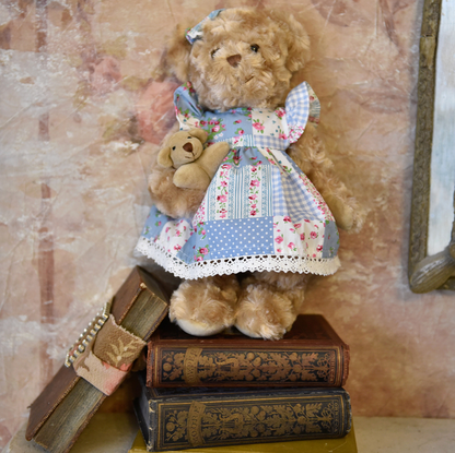 Teddy bear in a patchwork dress standing on vintage books. BLUE FLORAL PATCH-WORK DRESS TEDDY & BABY | POWELL CRAFT