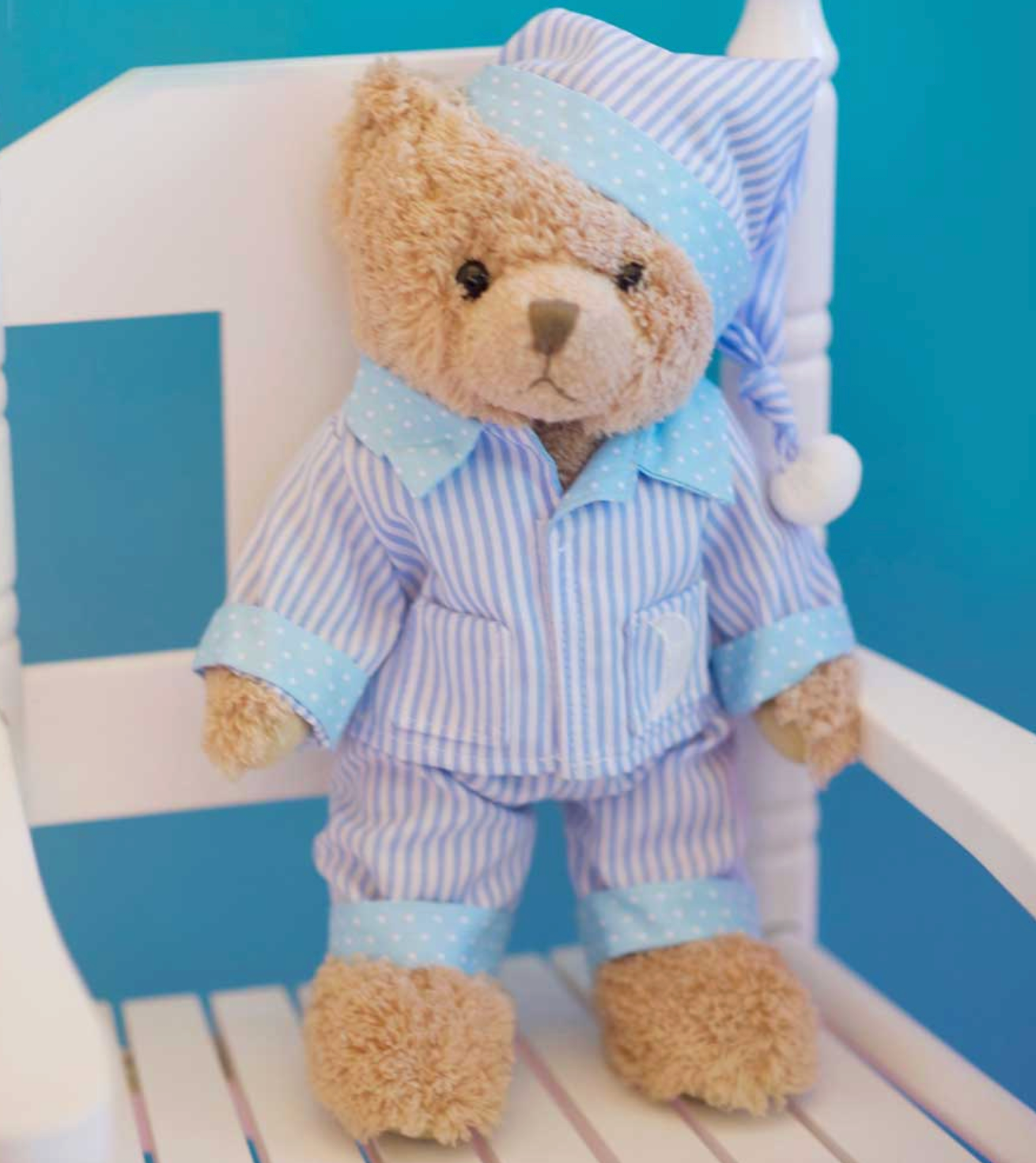Powell Craft cuddly bear in blue nightwear.