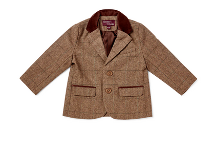 Eleanor Charles Boys Moloney Tweed Jacket in Brown trim colourway photographed flat lay from the front; tailored children's jacket in warm caramel-brown herringbone tweed; deep chocolate brown velvet notched lapel collar; two branded Eleanor Charles horn buttons in dark brown on the front button placket; two lower flap pockets with deep chocolate brown velvet contrast piping along the lower pocket flap edges; purple Eleanor Charles woven brand label at the inner collar neckline