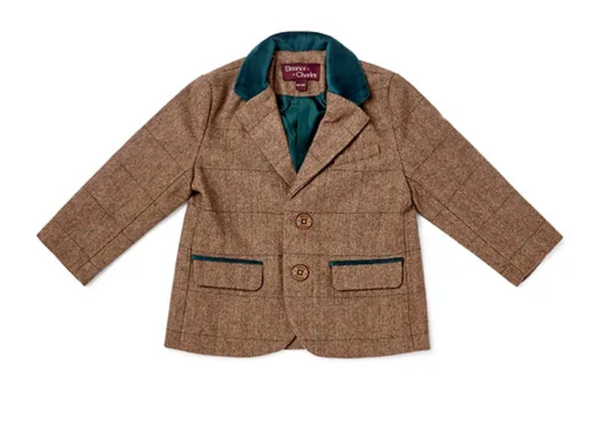 Eleanor Charles Boys Moloney Tweed Jacket in Teal Green trim colourway photographed flat lay from the front; warm caramel-brown herringbone tweed; peacock teal-blue velvet notched lapel collar; two branded Eleanor Charles horn buttons in warm brown on the front button placket; two lower flap pockets with peacock teal-blue velvet contrast piping; the teal velvet lining faintly visible at the jacket hem and lapel fold