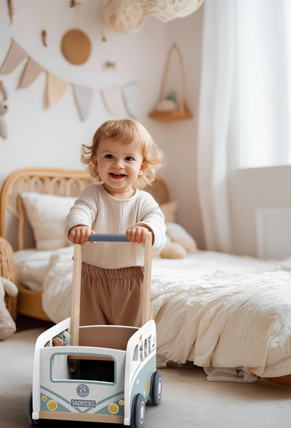 Child playing with a toy campervan walker in a bedroom CAMPER VAN MULTI ACTIVITY WOODEN WALKER | SPEEDY MONKEY 