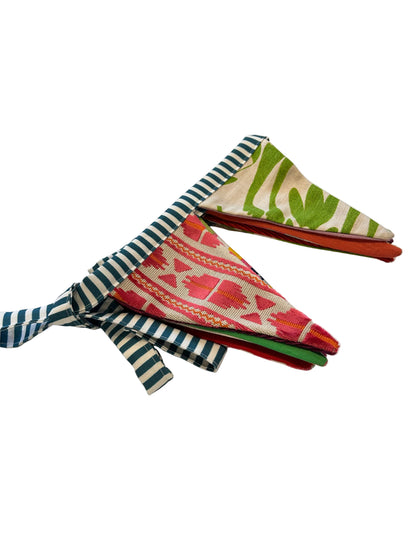 Colorful fabric samples on a white surface with a blurred background