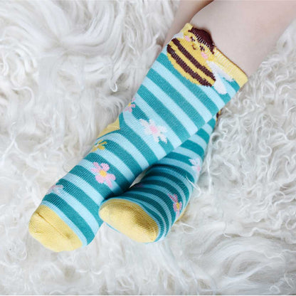 Colorful striped socks with floral designs on a fluffy white surface. CHILDREN'S BEE & BLUE STRIPE SOCKS - 3 SIZES | POWELL CRAFT