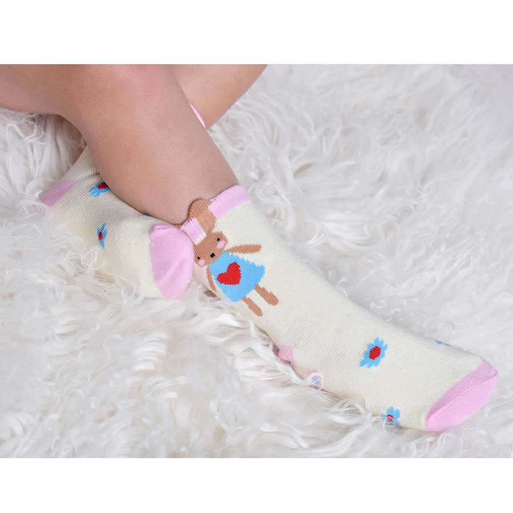 Baby feet wearing colorful socks with cartoon designs on a fluffy white surface. CHILDREN'S BUNNY RABBIT & DAISY SOCKS - 3 SIZES | POWELL CRAFT