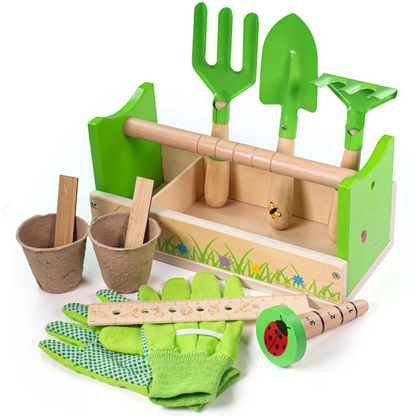 Children's wooden gardening caddy set in green, beige, and brown colors with various garden tools including a trowel, fork, rake, gloves, and a measuring stick, decorated with flower and ladybird motifs. CHILDREN'S GARDENING CADDY WITH TOOLS | BIGJIGS