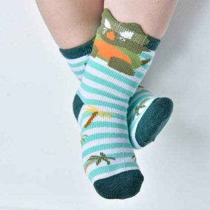 A pair of children's socks with green and white stripes and dinosaur motifs, including a triceratops design at the top. CHILDREN'S GREEN DINOSAUR STRIPE SOCKS - 3 SIZES | POWELL CRAFT