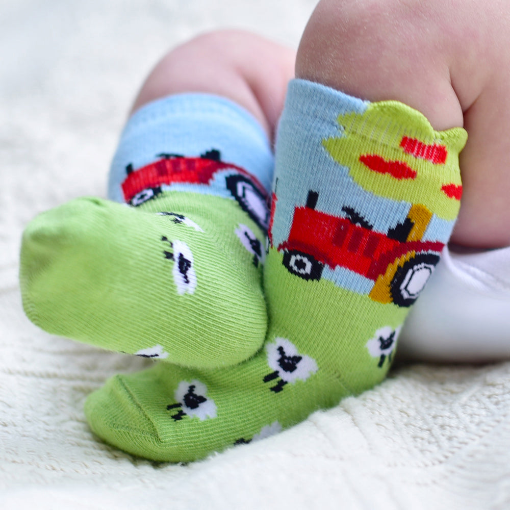 A pair of children's socks with tractor motifs in green and blue colors. CHILDREN'S TRACTOR & SHEEP SOCKS - 4 SIZES | POWELL CRAFT