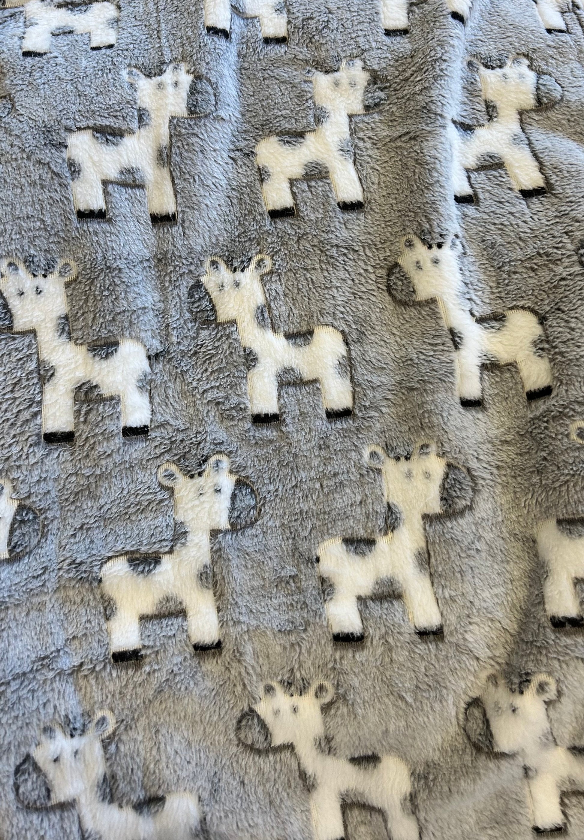 Pattern of white  giraffe shapes on a textured gray background. COSY BABY WRAP | GREY GIRAFFE