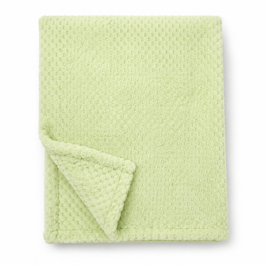 Snuggle Baby moss green cosy baby wrap — folded soft fleece wrap with waffle honeycomb texture throughout in a soft mint-green, showing corner turned back to reveal the texture detail, on white background