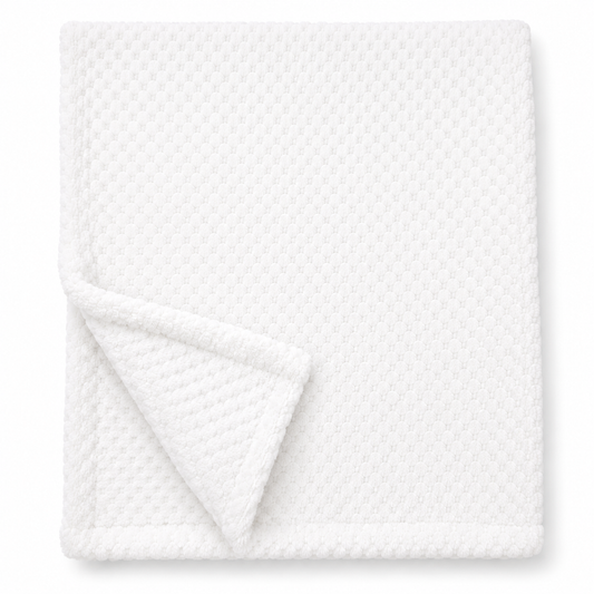 Snuggle Baby classic white cosy baby wrap — folded soft fleece wrap with waffle honeycomb texture throughout in bright white, showing corner turned back to reveal the texture detail, on white background