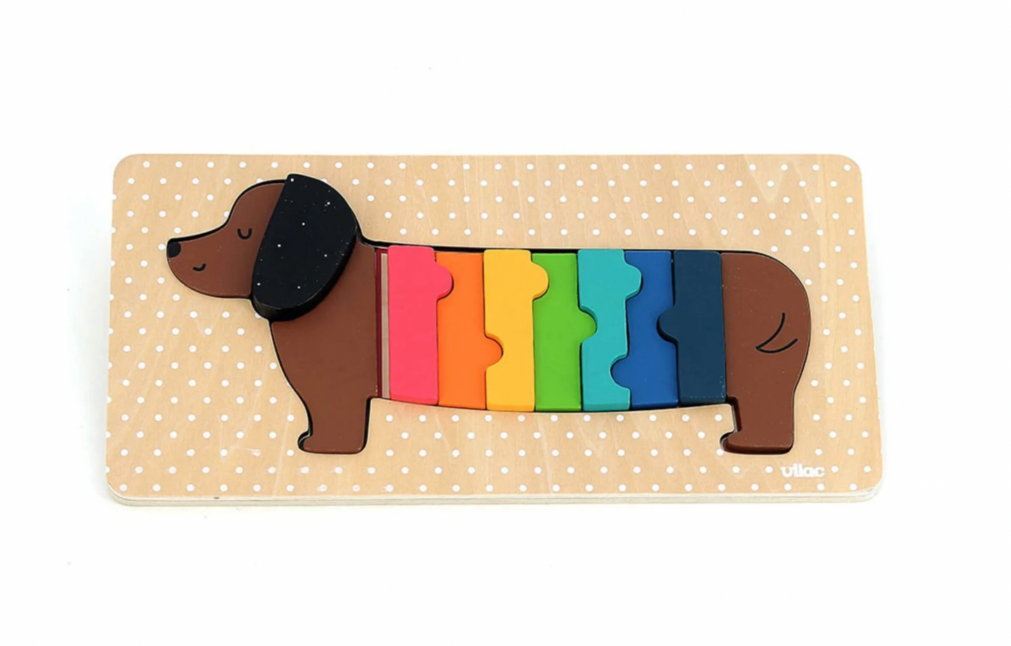 Colorful dachshund-shaped puzzle on a beige background with white polka dots