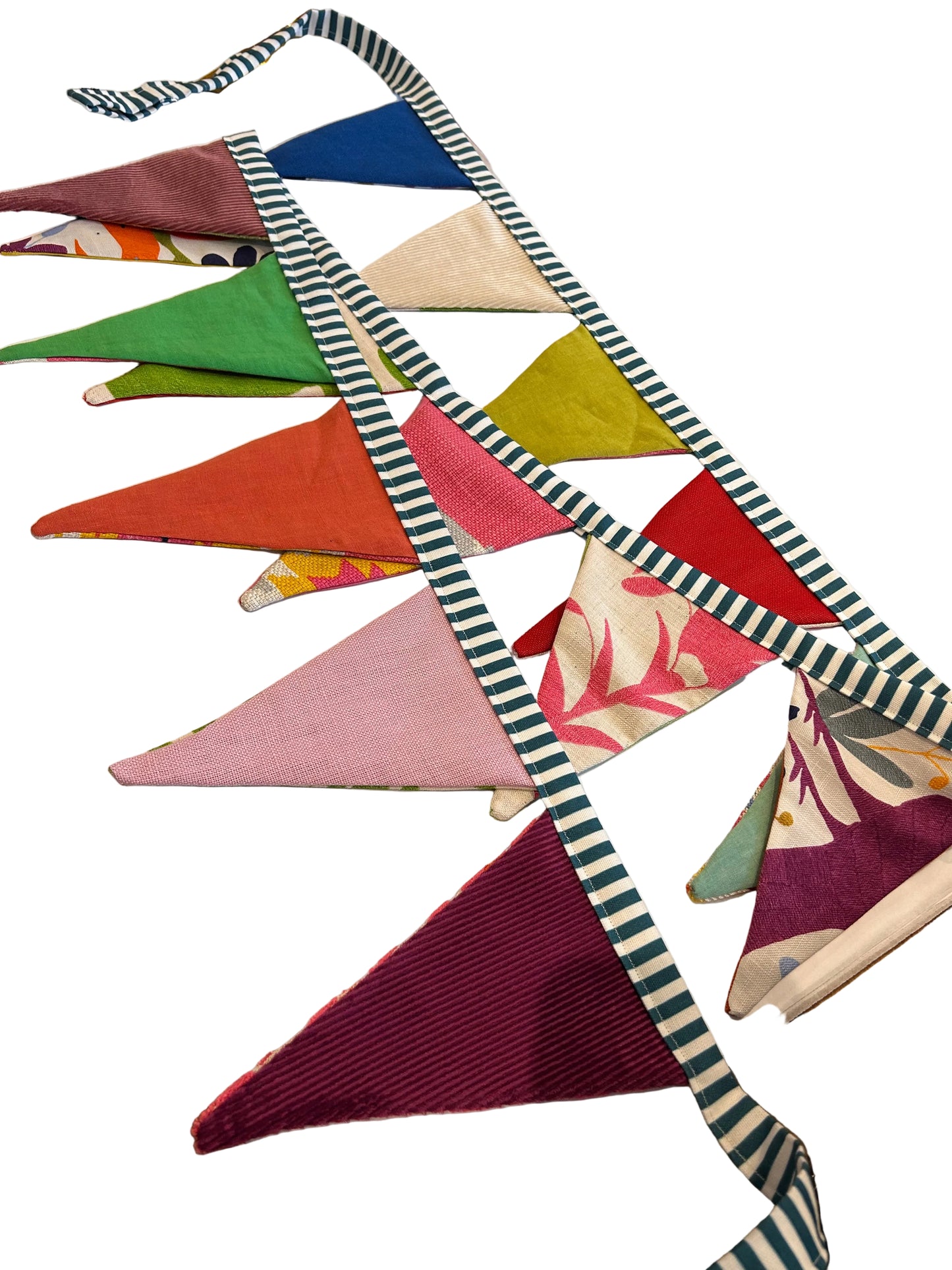 Colorful fabric bunting on a wooden surface