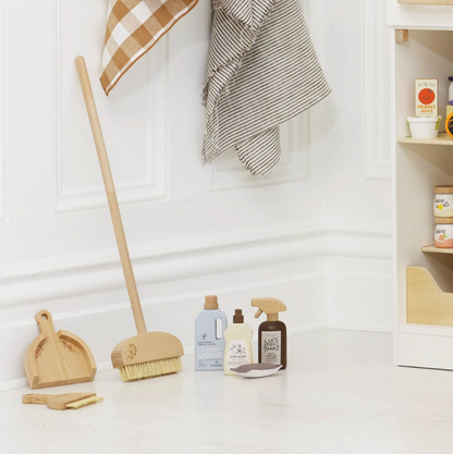 Cleaning supplies including a broom, dustpan, and cleaning bottles on a white surface with a neutral background. ECO-FRIENDLY WOODEN TOY CLEANING SET | LE TOY VAN
