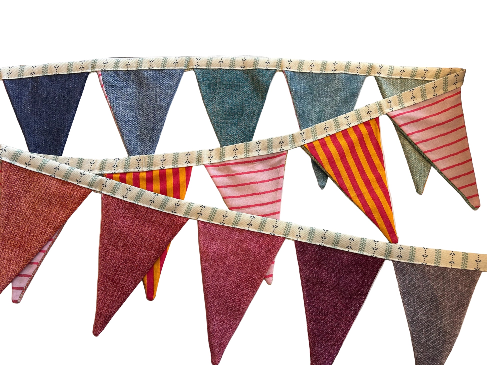 Fabric bunting with colorful triangular flags on a wooden surface