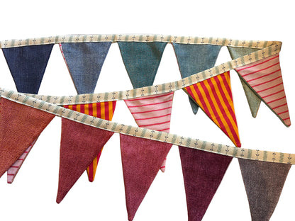 Fabric bunting with colorful triangular flags on a wooden surface