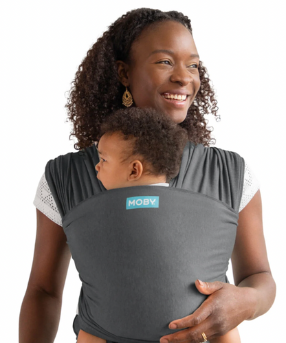 Woman carrying a child in a Moby baby carrier. ELEMENTS SOFT & ADJUSTABLE FEATHER KNIT BABY WRAP CARRIER - 2 COLOURS | MOBY