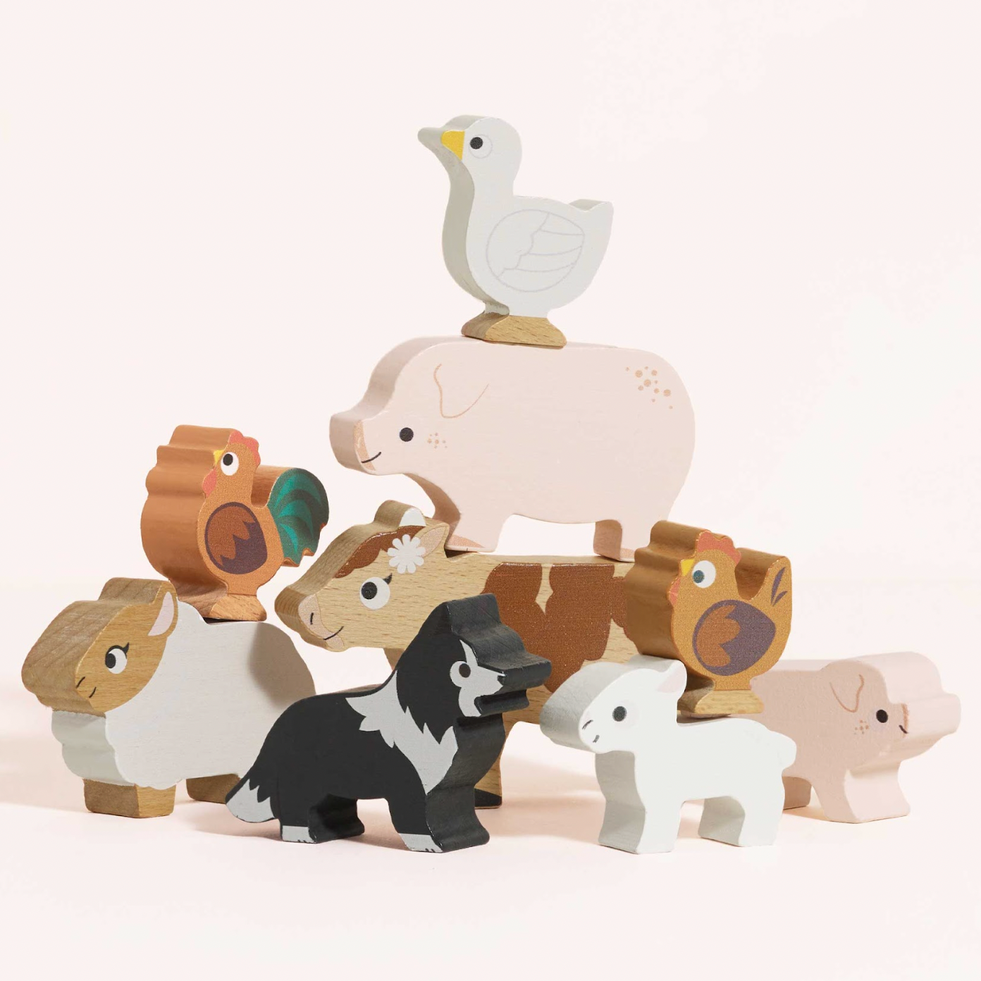 Set of wooden animal figurines on a light background. FARMYARD STACKING WOODEN ANIMALS & BAG | LE TOY VAN