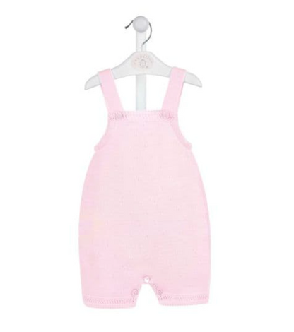 A pink knitted romper for babies, displayed on a hanger. FINE KNIT BABY ROMPER - BABY PINK | DANDELION